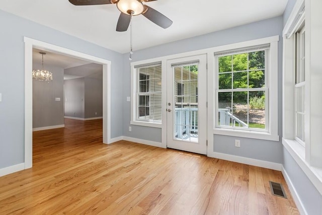 450 Carefree Ct, Niles, MI 49120 - doorway to outside featuring light wood-style floors, ceiling fan, and a chandelier
