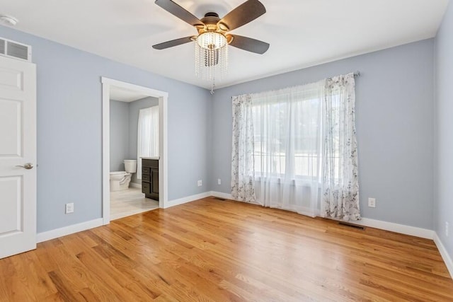 450 Carefree Ct, Niles, MI 49120 - unfurnished bedroom featuring wood finished floors, connected bathroom, and ceiling fan