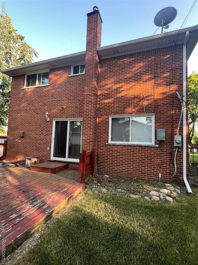 20120 N Covington Pkwy, Southfield, MI 48221 - rear view of house with a deck, brick siding, a chimney, and a yard