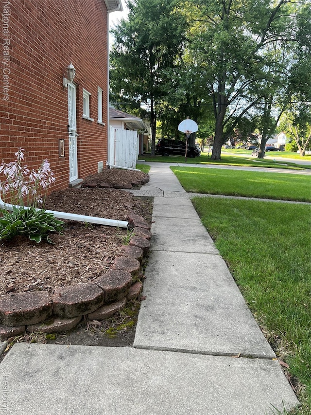 20120 N Covington Pkwy, Southfield, MI 48221 - view of side of home featuring a yard and brick siding