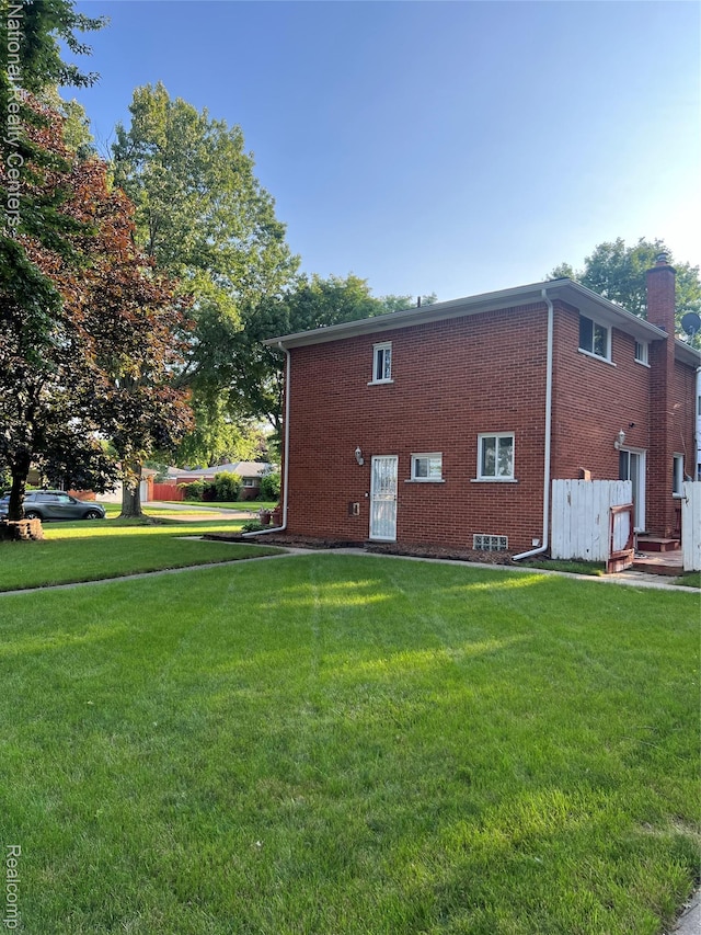 20120 N Covington Pkwy, Southfield, MI 48221 - view of side of home featuring a yard, a chimney, and brick siding