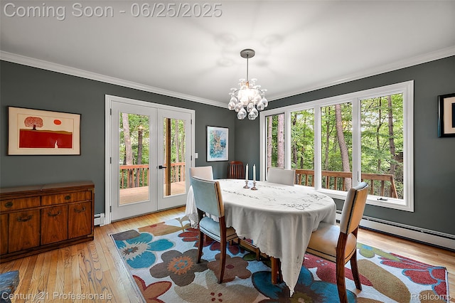 7340 Deer Lake Rd, Clarkston, MI 48346 - dining room with french doors, ornamental molding, a chandelier, light wood-style flooring, and a baseboard heating unit
