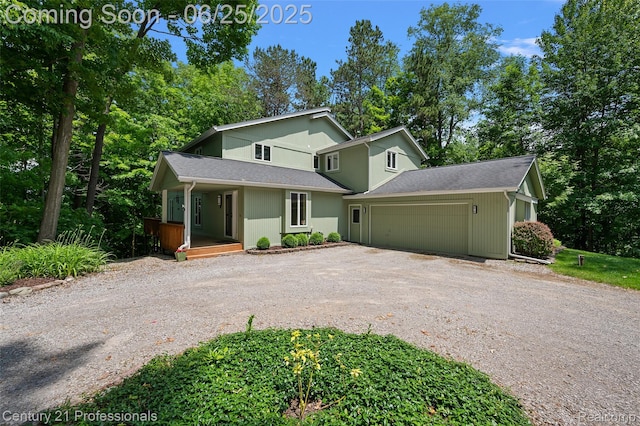 7340 Deer Lake Rd, Clarkston, MI 48346 - mid-century inspired home with driveway, a porch, a garage, and a shingled roof