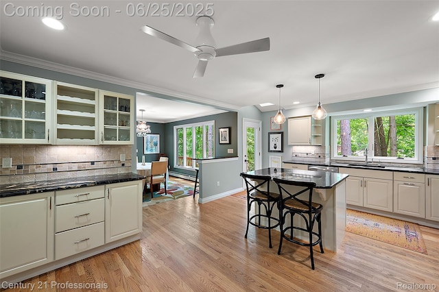 7340 Deer Lake Rd, Clarkston, MI 48346 - kitchen featuring open shelves, ornamental molding, decorative backsplash, light wood-style floors, and glass insert cabinets