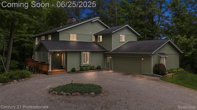 7340 Deer Lake Rd, Clarkston, MI 48346 - view of front of house with driveway, a chimney, an attached garage, and a shingled roof