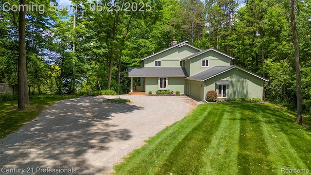 7340 Deer Lake Rd, Clarkston, MI 48346 - traditional home featuring dirt driveway, a front yard, a garage, a chimney, and covered porch