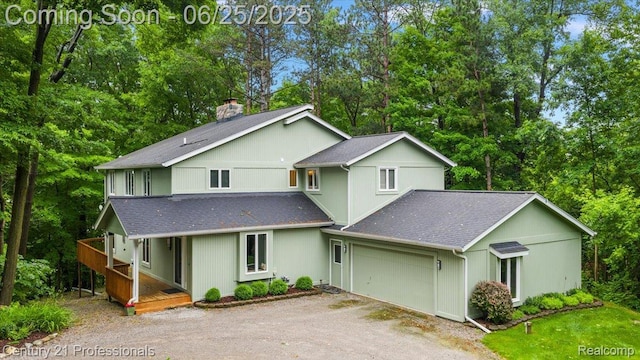 7340 Deer Lake Rd, Clarkston, MI 48346 - view of front of property featuring a shingled roof, driveway, an attached garage, and a porch
