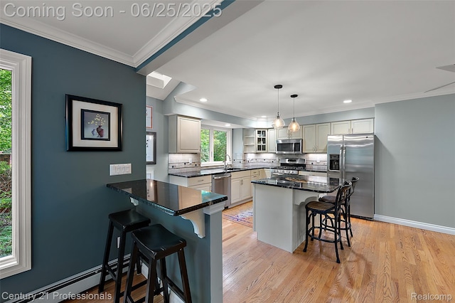 7340 Deer Lake Rd, Clarkston, MI 48346 - kitchen with stainless steel appliances, a breakfast bar, tasteful backsplash, baseboard heating, and crown molding