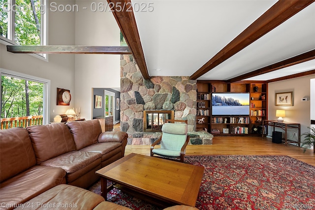 7340 Deer Lake Rd, Clarkston, MI 48346 - living room featuring wood finished floors, beamed ceiling, and a fireplace