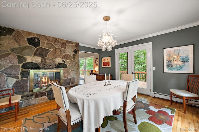 7340 Deer Lake Rd, Clarkston, MI 48346 - dining area with crown molding, hardwood / wood-style floors, baseboard heating, a fireplace, and a chandelier