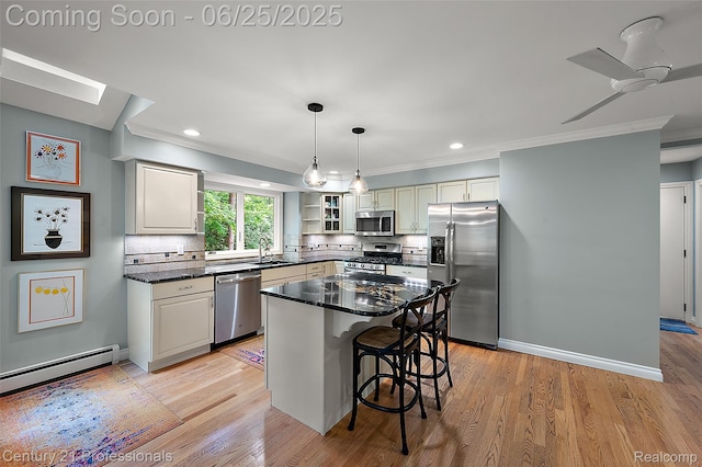 7340 Deer Lake Rd, Clarkston, MI 48346 - kitchen with stainless steel appliances, a baseboard heating unit, decorative backsplash, ornamental molding, and a kitchen bar