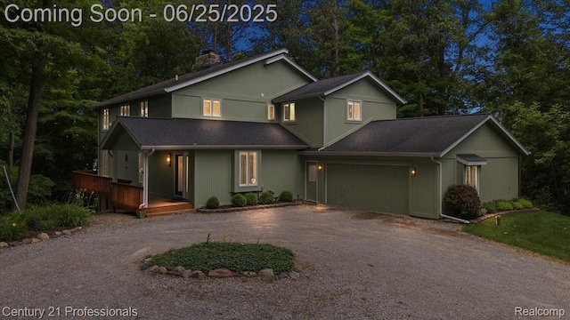 7340 Deer Lake Rd, Clarkston, MI 48346 - view of front of house featuring driveway, a garage, a chimney, and a porch