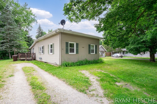 160 Division St, Saranac, MI 48881 - view of property exterior featuring a wooden deck, a yard, and driveway