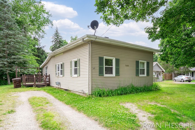 160 Division St, Saranac, MI 48881 - view of side of home with a deck and a yard