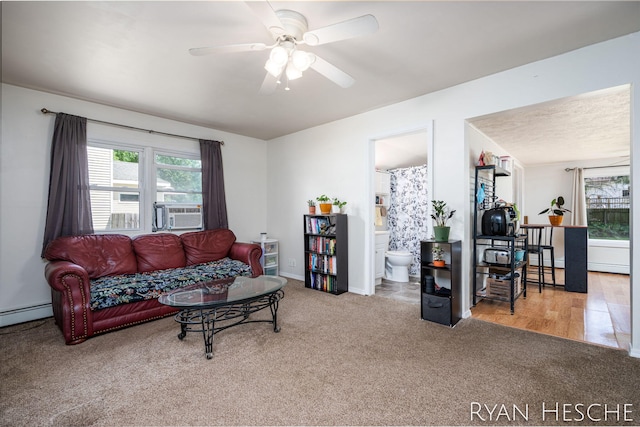 160 Division St, Saranac, MI 48881 - carpeted living room featuring a ceiling fan, healthy amount of natural light, cooling unit, and a baseboard radiator