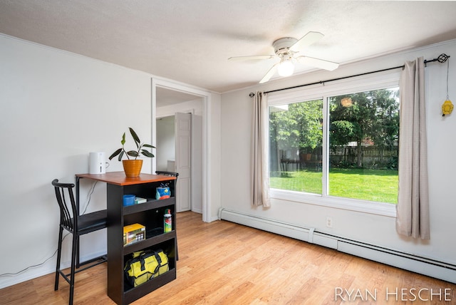 160 Division St, Saranac, MI 48881 - dining area featuring a baseboard radiator, ceiling fan, light wood finished floors, and crown molding