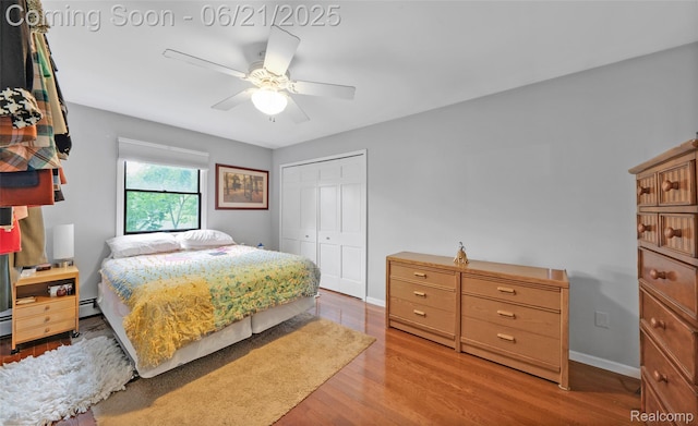 47645 Sugarbush Rd, Chesterfield, MI 48047 - bedroom with a closet, wood finished floors, a baseboard radiator, and a ceiling fan