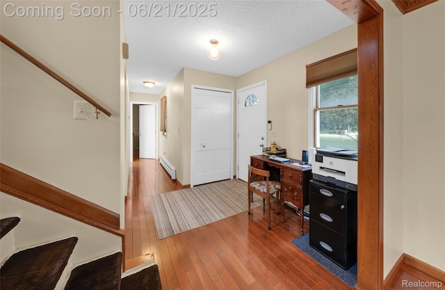 47645 Sugarbush Rd, Chesterfield, MI 48047 - home office with a baseboard heating unit, wood-type flooring, and a textured ceiling