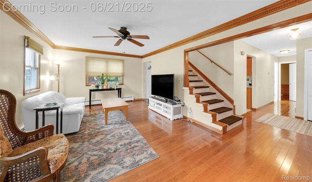 47645 Sugarbush Rd, Chesterfield, MI 48047 - living room featuring ceiling fan, stairway, wood finished floors, a baseboard radiator, and crown molding