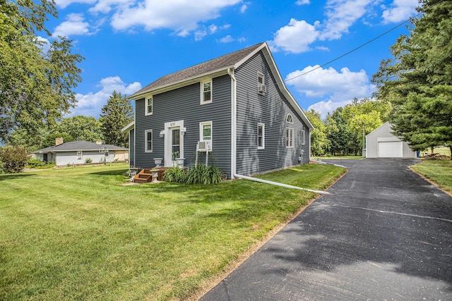 8150 B Dr N, Battle Creek, MI 49014 - view of front of house with a detached garage, an outbuilding, and a front yard