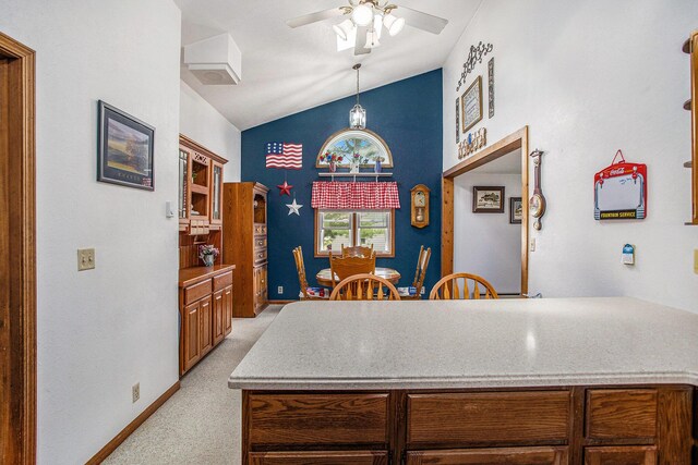 8150 B Dr N, Battle Creek, MI 49014 - kitchen featuring light carpet, a ceiling fan, decorative light fixtures, high vaulted ceiling, and a peninsula