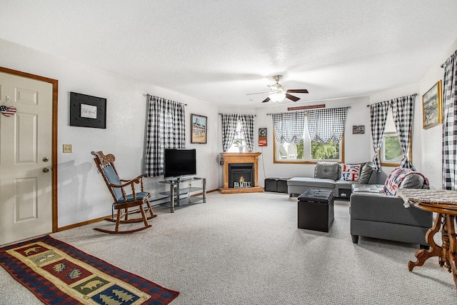 8150 B Dr N, Battle Creek, MI 49014 - carpeted living area with a ceiling fan, a textured ceiling, and a fireplace with raised hearth