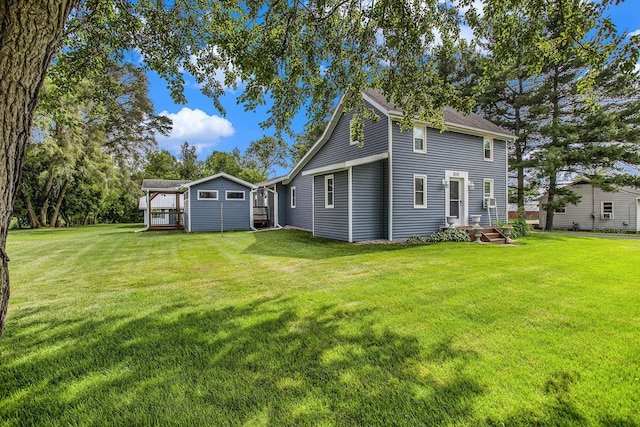 8150 B Dr N, Battle Creek, MI 49014 - back of house featuring a lawn and an outbuilding