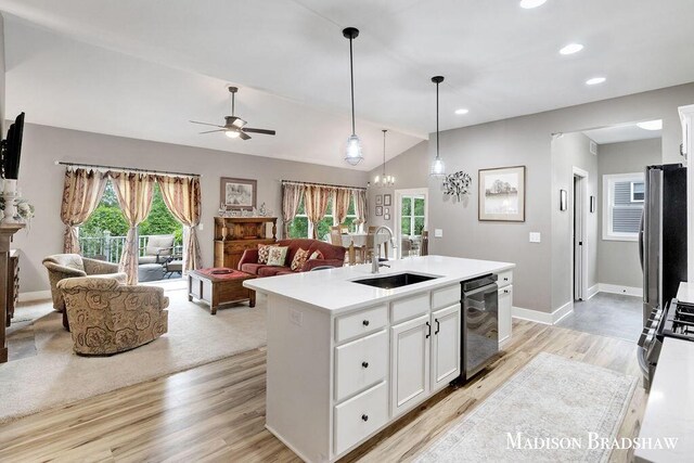 1728 N Brandon Ridge Dr NW, Walker, MI 49544 - kitchen with appliances with stainless steel finishes, vaulted ceiling, light wood-style flooring, open floor plan, and light countertops