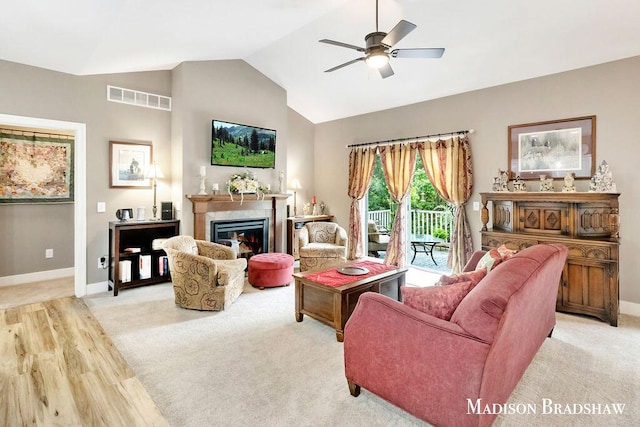 1728 N Brandon Ridge Dr NW, Walker, MI 49544 - living area featuring lofted ceiling, a fireplace, a ceiling fan, and light carpet
