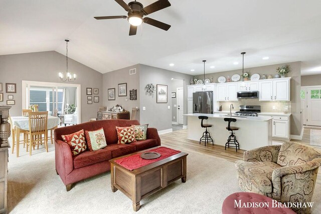 1728 N Brandon Ridge Dr NW, Walker, MI 49544 - living room featuring a ceiling fan, recessed lighting, vaulted ceiling, a chandelier, and light wood finished floors