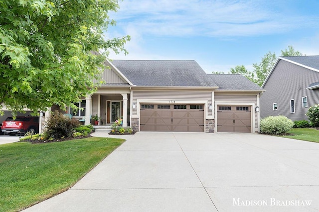 1728 N Brandon Ridge Dr NW, Walker, MI 49544 - craftsman house featuring a garage, a front lawn, driveway, board and batten siding, and stone siding