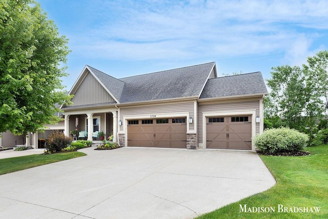 1728 N Brandon Ridge Dr NW, Walker, MI 49544 - craftsman-style house featuring a garage, driveway, a front yard, a porch, and board and batten siding