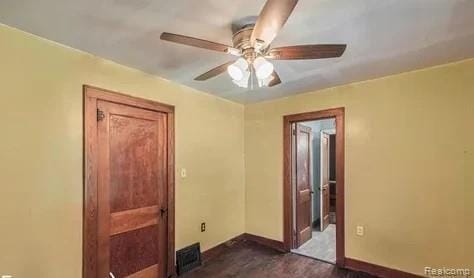 1460 S Dye Rd, Flint, MI 48532 - empty room with a ceiling fan and dark colored carpet