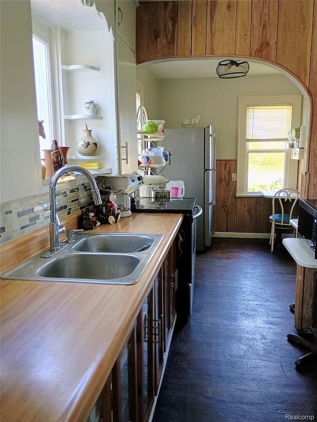 1460 S Dye Rd, Flint, MI 48532 - kitchen with open shelves, plenty of natural light, wainscoting, dark wood-type flooring, and backsplash