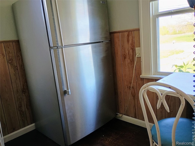 1460 S Dye Rd, Flint, MI 48532 - kitchen featuring freestanding refrigerator, wood walls, and wainscoting