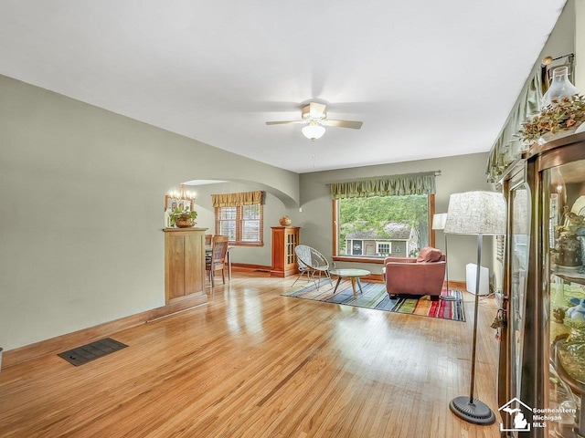 2252 W Temperance Rd, Temperance, MI 48182 - living area with arched walkways, wood finished floors, and ceiling fan