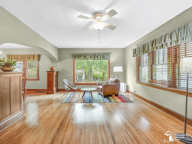2252 W Temperance Rd, Temperance, MI 48182 - living area with arched walkways, wood finished floors, and ceiling fan