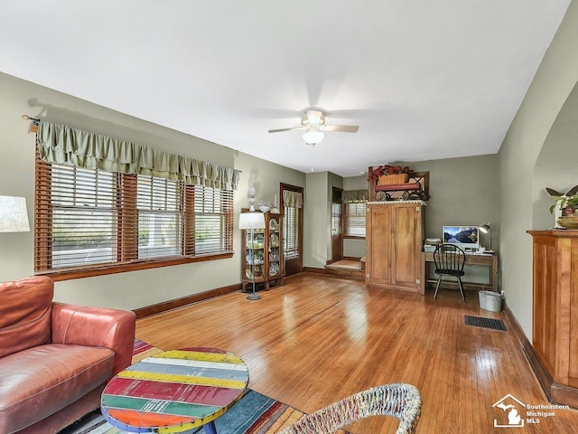 2252 W Temperance Rd, Temperance, MI 48182 - living area featuring light wood-style flooring, a ceiling fan, an office area, and arched walkways