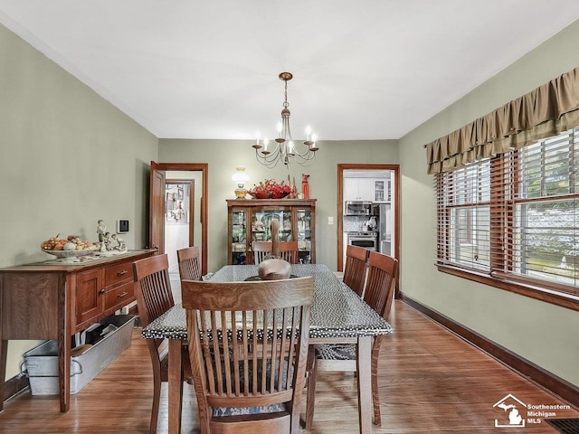 2252 W Temperance Rd, Temperance, MI 48182 - dining area with a chandelier and wood finished floors