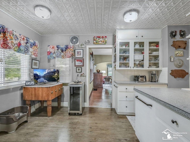 2252 W Temperance Rd, Temperance, MI 48182 - kitchen featuring beverage cooler, an ornate ceiling, plenty of natural light, wood finished floors, and light countertops