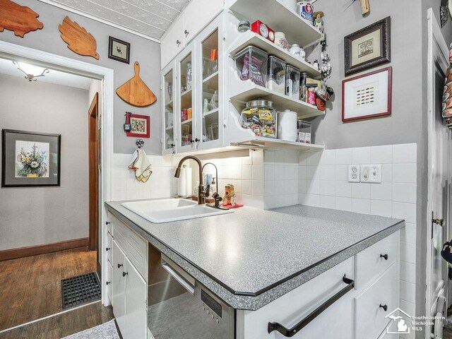 2252 W Temperance Rd, Temperance, MI 48182 - kitchen with dark wood finished floors, stainless steel dishwasher, white cabinets, and backsplash