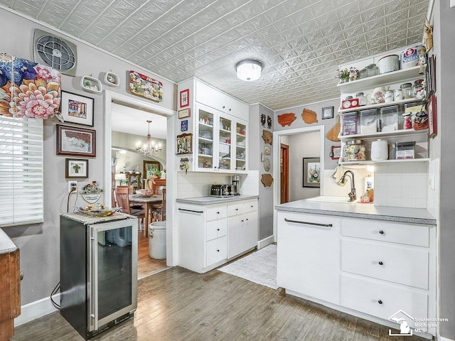 2252 W Temperance Rd, Temperance, MI 48182 - kitchen featuring an ornate ceiling, open shelves, light wood-style floors, white cabinetry, and a chandelier