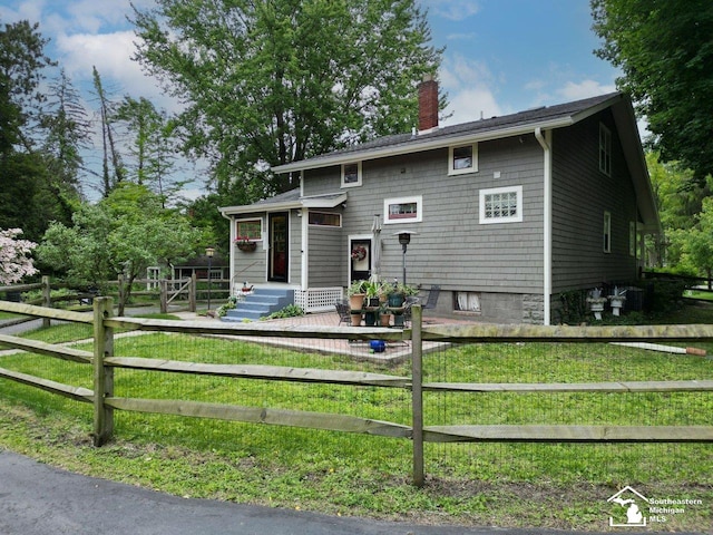 2252 W Temperance Rd, Temperance, MI 48182 - view of front of house featuring a chimney and a fenced front yard