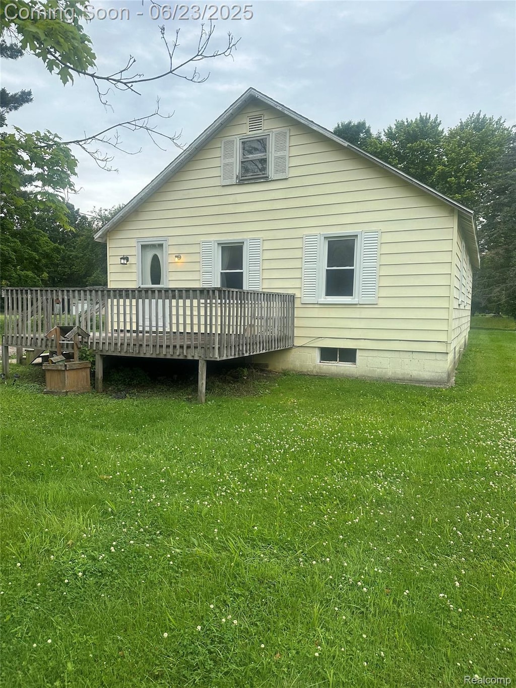 1106 S Vassar Rd, Burton, MI 48509 - rear view of property featuring a deck and a yard