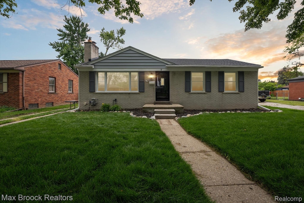 32729 W Chicago St, Livonia, MI 48150 - view of front of property with brick siding, a front lawn, and a chimney