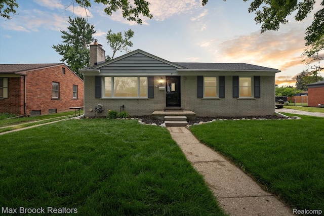 32729 W Chicago St, Livonia, MI 48150 - view of front of property with brick siding, a front lawn, and a chimney