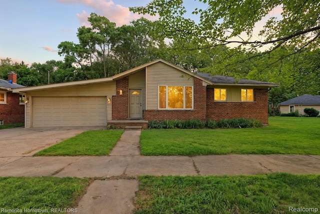 42424 Bradner Ct, Plymouth, MI 48170 - view of front of home featuring a garage, brick siding, a lawn, and concrete driveway