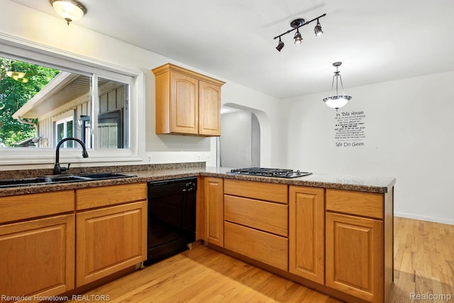42424 Bradner Ct, Plymouth, MI 48170 - kitchen featuring black dishwasher, a peninsula, stainless steel gas cooktop, arched walkways, and light wood-type flooring