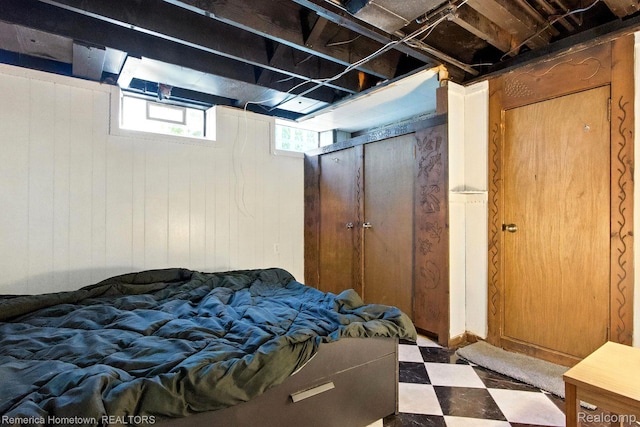 42424 Bradner Ct, Plymouth, MI 48170 - bedroom with tile patterned floors and wooden walls