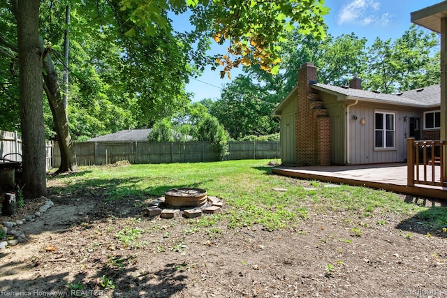 42424 Bradner Ct, Plymouth, MI 48170 - fenced backyard with an outdoor fire pit and a wooden deck